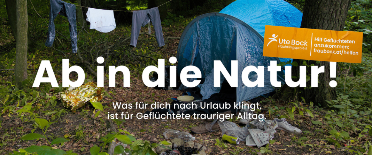 Schriftzug "Ab in die Natur" vor einem Zelt und einer Wäscheleine mit Kleidung im Wald